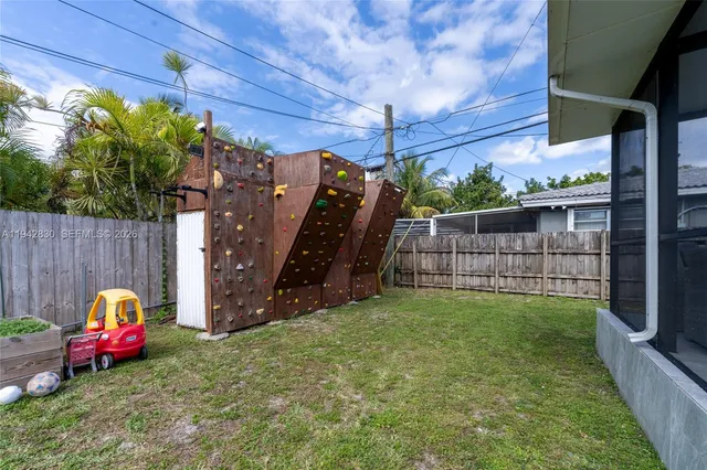 a view of a house with a backyard and a patio