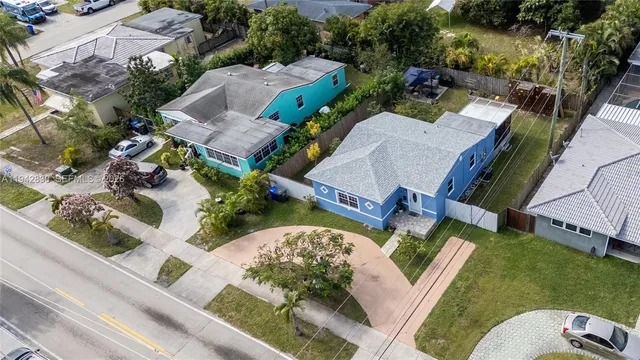 an aerial view of multiple houses with yard