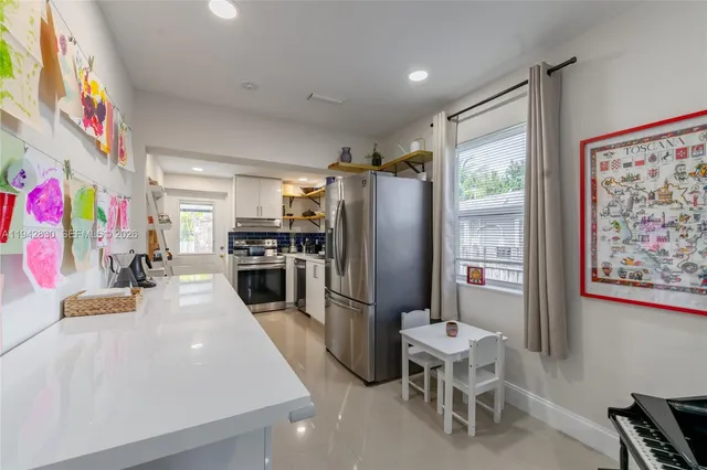 a kitchen with stainless steel appliances a refrigerator and a stove