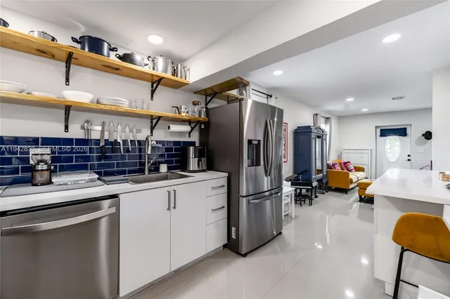 a kitchen with stainless steel appliances a refrigerator and a sink