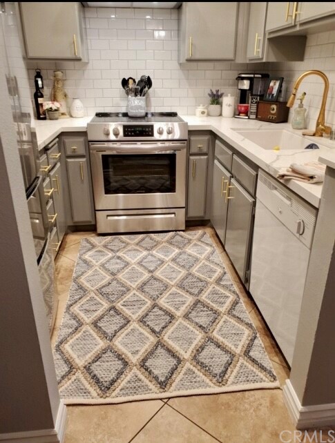 3110 Cochise Way, Unit 103 Fullerton, CA 92833 - Photo 1 of 14 a kitchen with a sink stove and cabinets