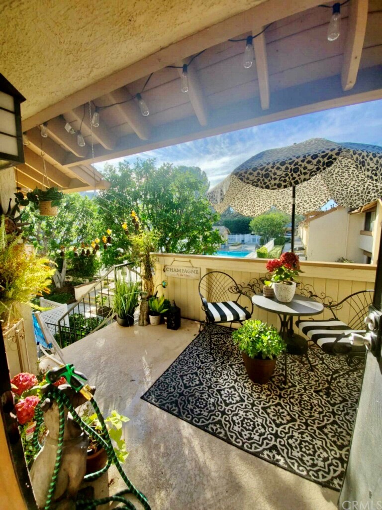 3110 Cochise Way, Unit 103 Fullerton, CA 92833 - Photo 11 of 14 a view of a patio with table and chairs potted plants