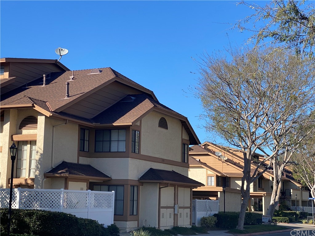 3110 Cochise Way, Unit 103 Fullerton, CA 92833 - Photo 13 of 14 a front view of a house with a yard