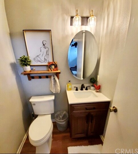 3110 Cochise Way, Unit 103 Fullerton, CA 92833 - Photo 4 of 14 a bathroom with a toilet sink and mirror