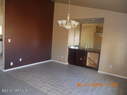 15721 Fisk Road Yakima, WA 98908 - Photo 5 of 9 an empty room with a mirror and a bathroom