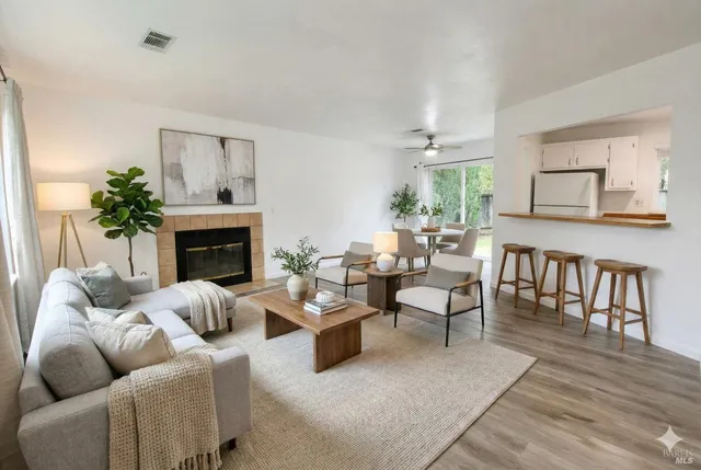 a living room with furniture a large window and a fireplace