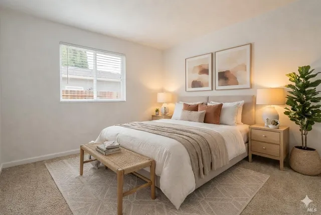 a bedroom with a bed and a painting on the wall