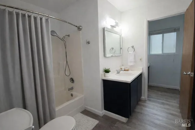 a bathroom with a sink vanity mirror and toilet
