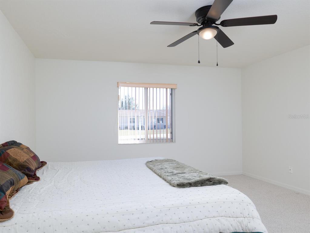 6086 Southwest 98th Loop Ocala, FL 34476 - Photo 11 of 49 a bedroom with a bed and a window