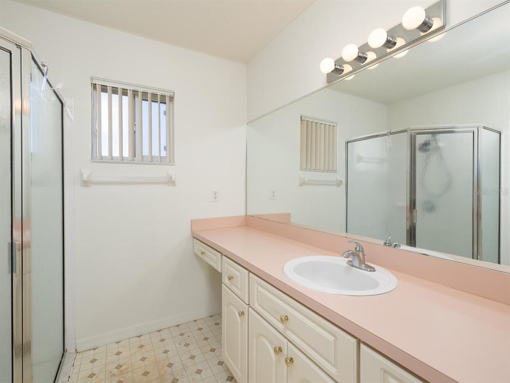 6086 Southwest 98th Loop Ocala, FL 34476 - Photo 13 of 49 a bathroom with a sink a vanity and a mirror
