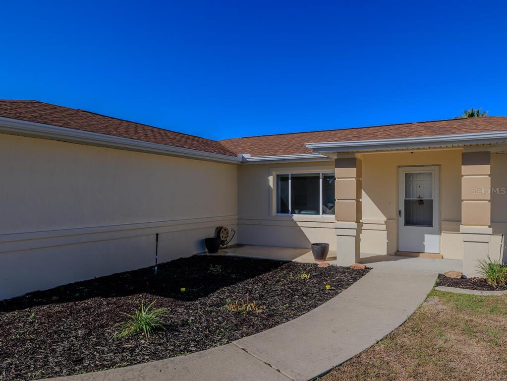 6086 Southwest 98th Loop Ocala, FL 34476 - Photo 24 of 49 a front view of a house with a yard