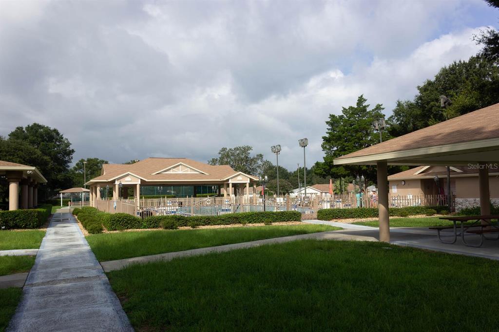 6086 Southwest 98th Loop Ocala, FL 34476 - Photo 42 of 49 a front view of a building with garden