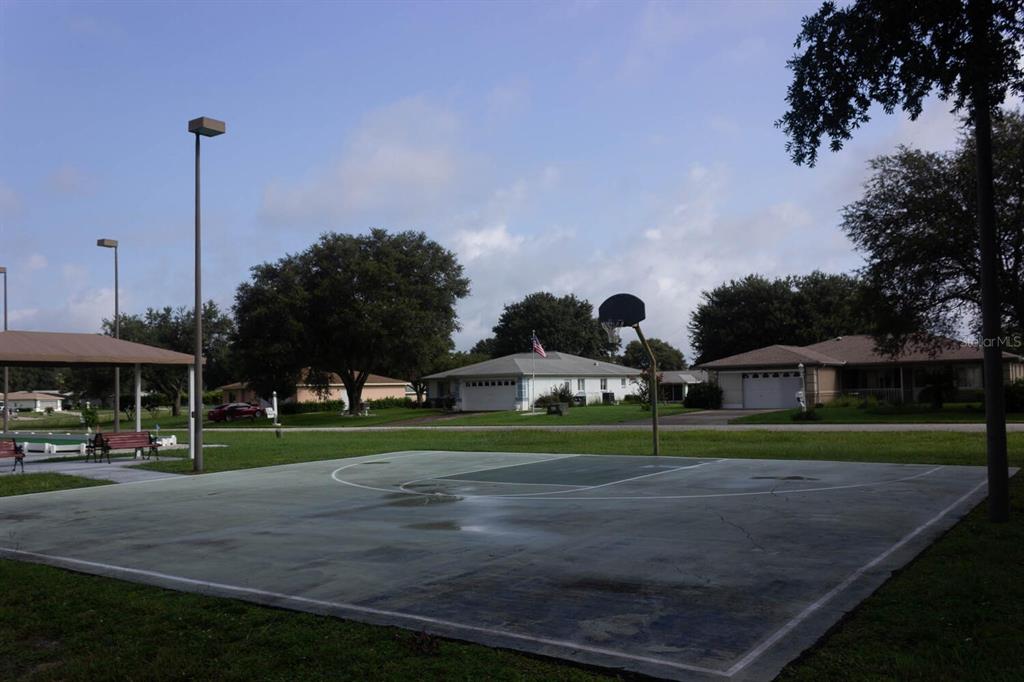 6086 Southwest 98th Loop Ocala, FL 34476 - Photo 48 of 49 a view of street with houses and trees in the background