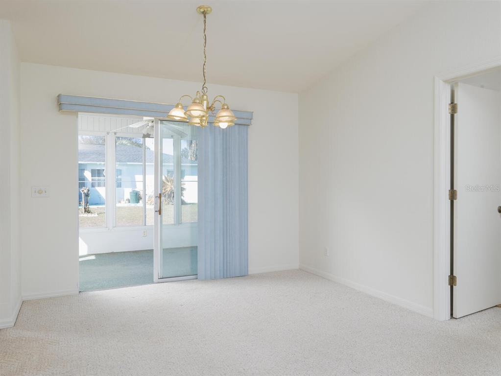 6086 Southwest 98th Loop Ocala, FL 34476 - Photo 7 of 49 a view of a room with windows and chandelier