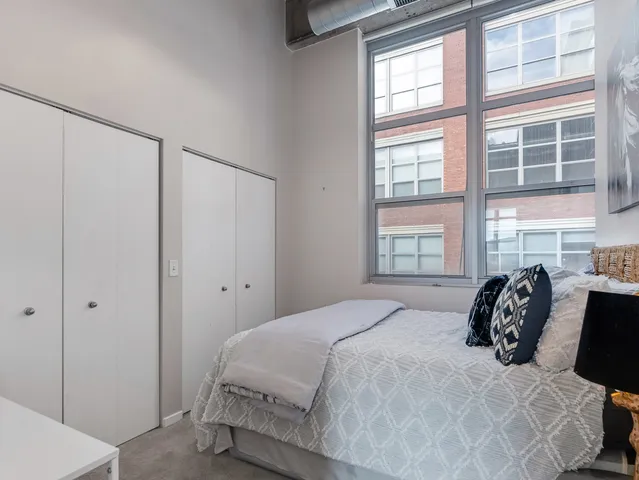 a bedroom with a bed and a window