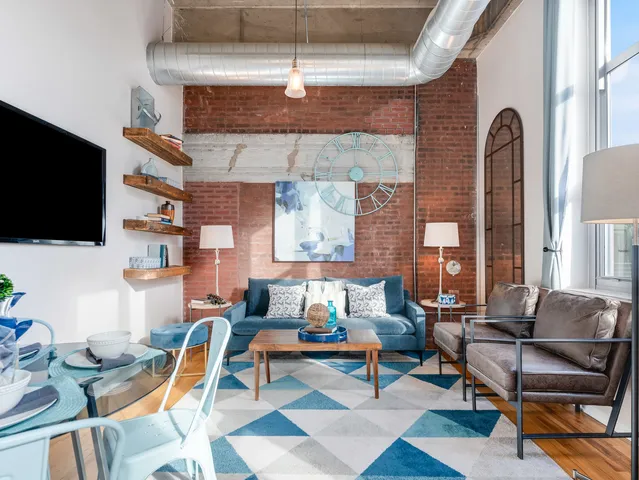 a living room with patio furniture and a flat screen tv