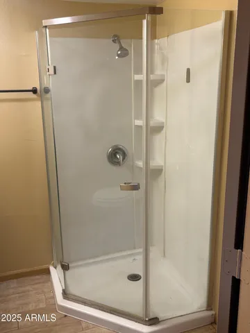 a bathroom with a glass shower door