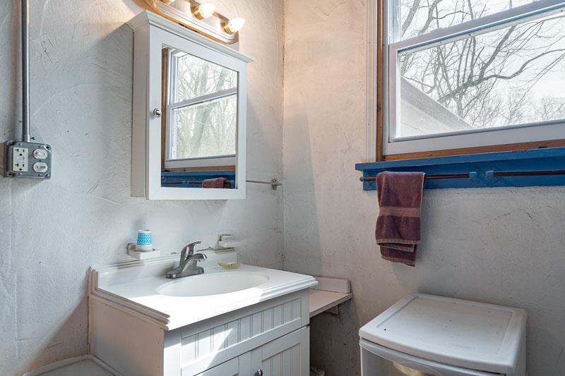 3134 North River Road Oregon, IL 61061 - Photo 16 of 59 a bathroom with a toilet sink and mirror