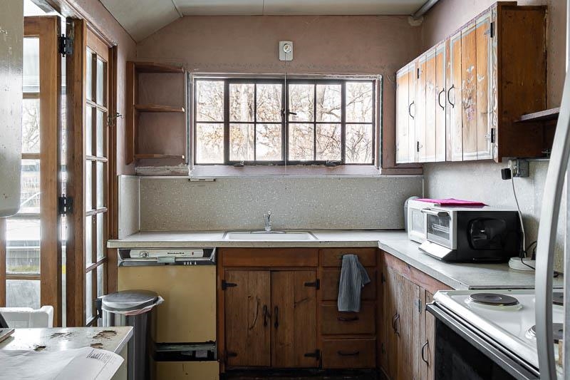 3134 North River Road Oregon, IL 61061 - Photo 28 of 59 a kitchen with a sink a window and cabinets