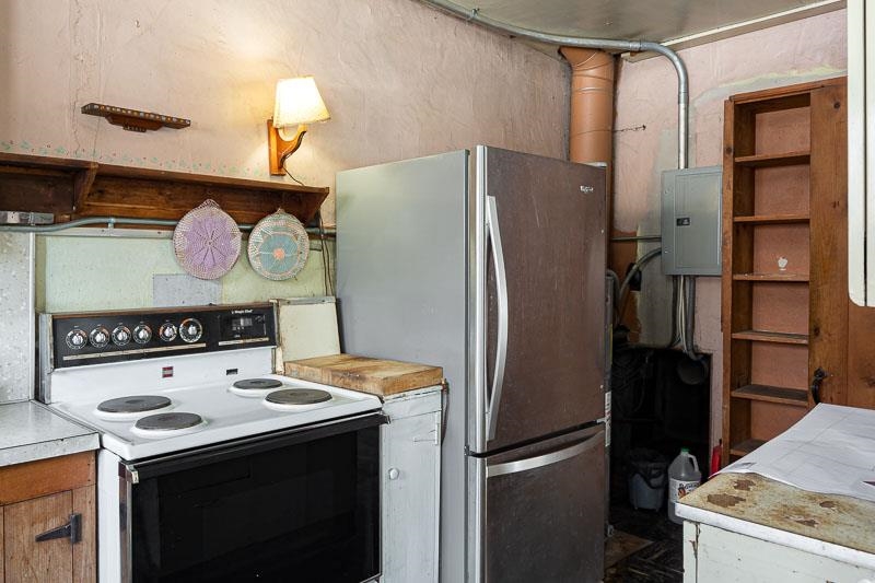 3134 North River Road Oregon, IL 61061 - Photo 29 of 59 a kitchen with a refrigerator and a stove