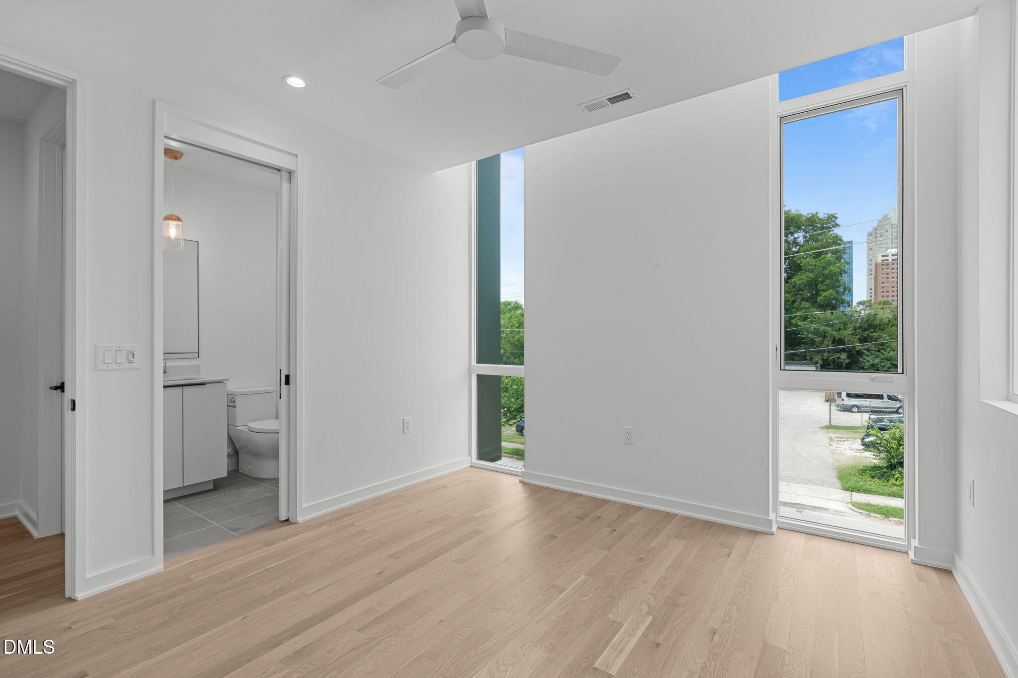 501 South Bloodworth Street, Unit 105 Raleigh, NC 27601 - Photo 29 of 59 a view of an empty room with a window and wooden floor