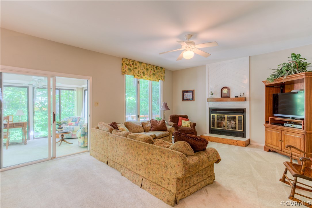 Open family room with gas fireplace is access to r
