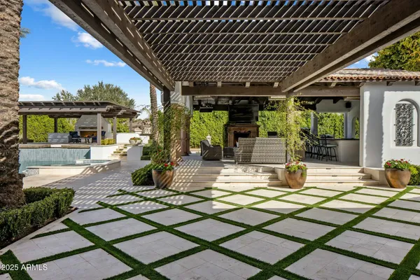 a view of a patio with table and chairs in front of building