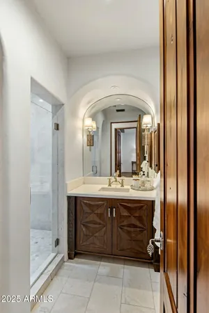 a bathroom with a granite countertop sink a mirror and a vanity