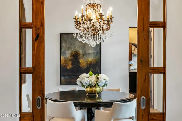a dining room view with chandelier and wooden floor