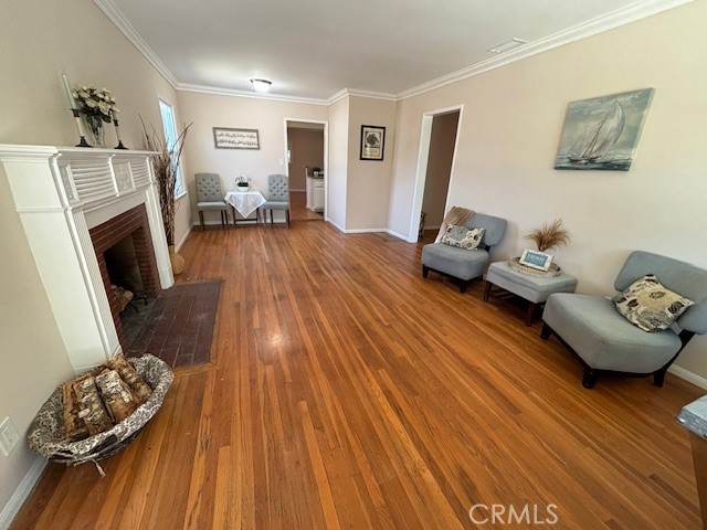 a bedroom with furniture and a wooden floor