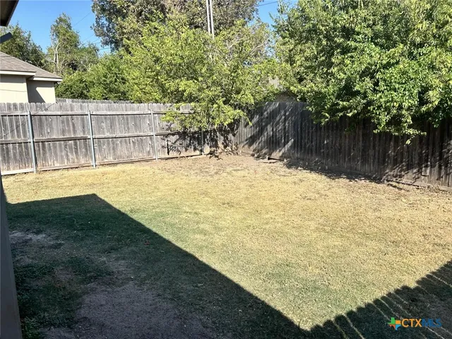 a view of a backyard of the house