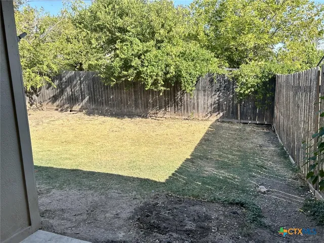 a view of a backyard of the house