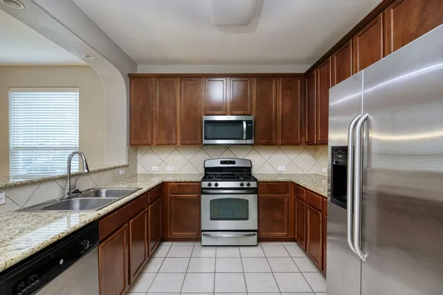 a kitchen with a sink stove and refrigerator
