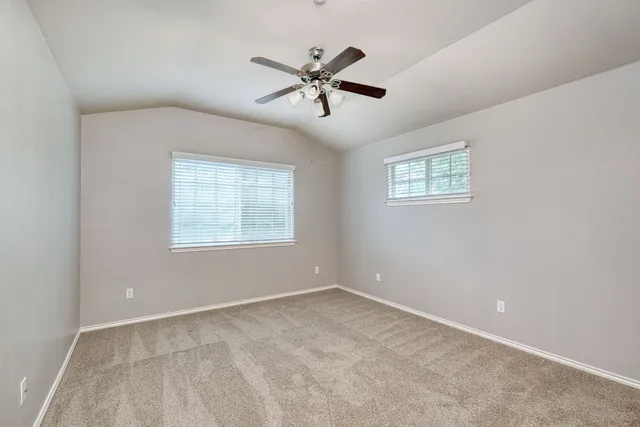 a view of a livingroom with a ceiling fan and window
