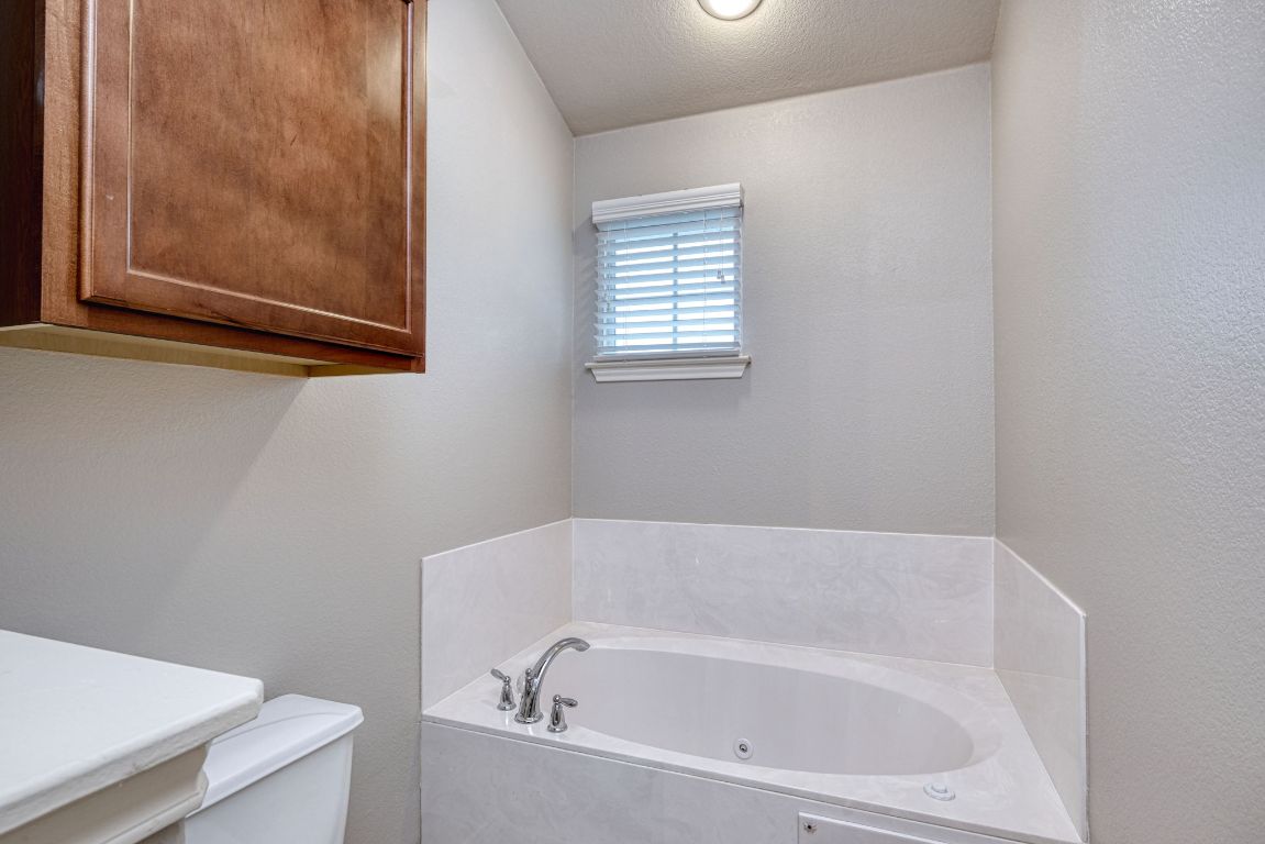 14815 Avery Ranch Boulevard, Unit 2502 Austin, TX 78717 - Photo 8 of 16 a white bath tub sitting next to a small window
