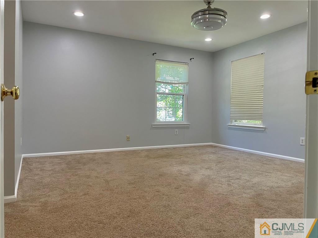 701 Timber Oaks Road Edison, NJ 08820 - Photo 12 of 23 wooden floor in an empty room with a window