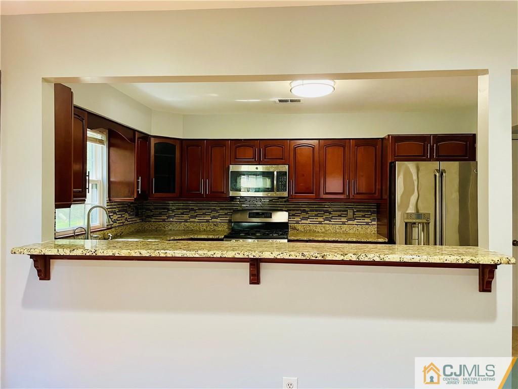 701 Timber Oaks Road Edison, NJ 08820 - Photo 9 of 23 a view of a living room with kitchen
