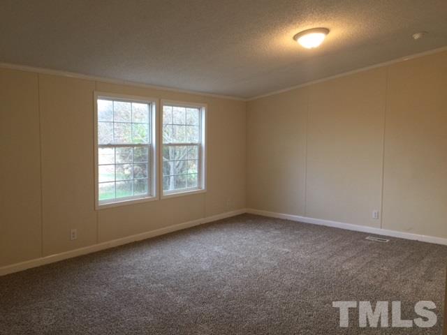 10835 Smith Road Middlesex, NC 27557 - Photo 7 of 13 an empty room with a empty space and windows