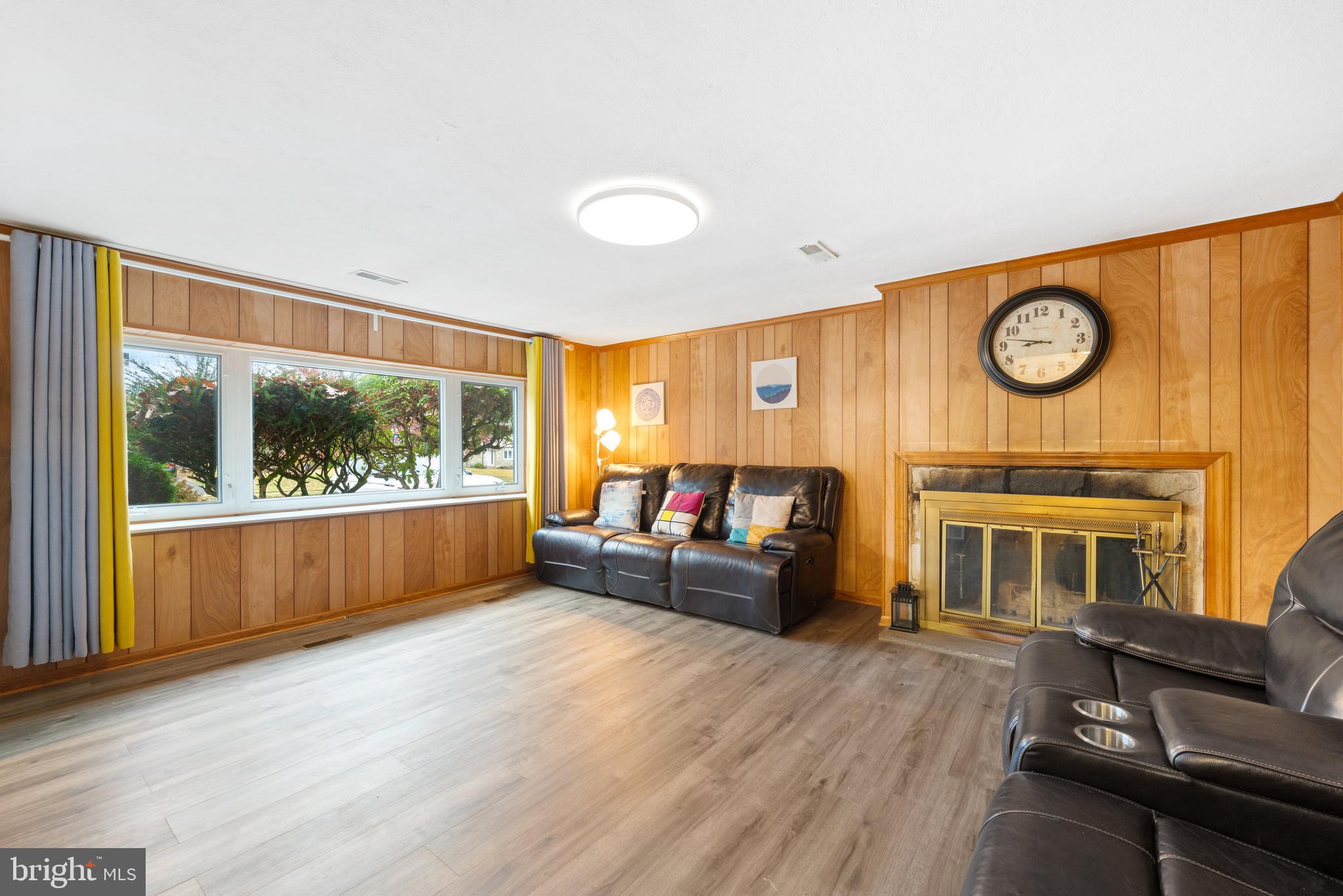 416 Emerson Road Huntingdon Valley, PA 19006 - Photo 9 of 36 a living room with furniture a fireplace and a large window with outer view