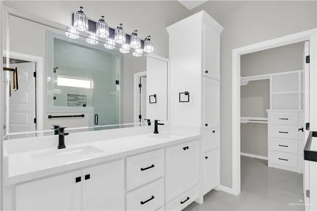 a bathroom with a double vanity sink mirror and shower