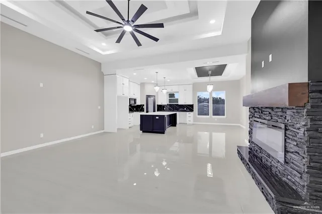 a large kitchen with a stove and a fireplace