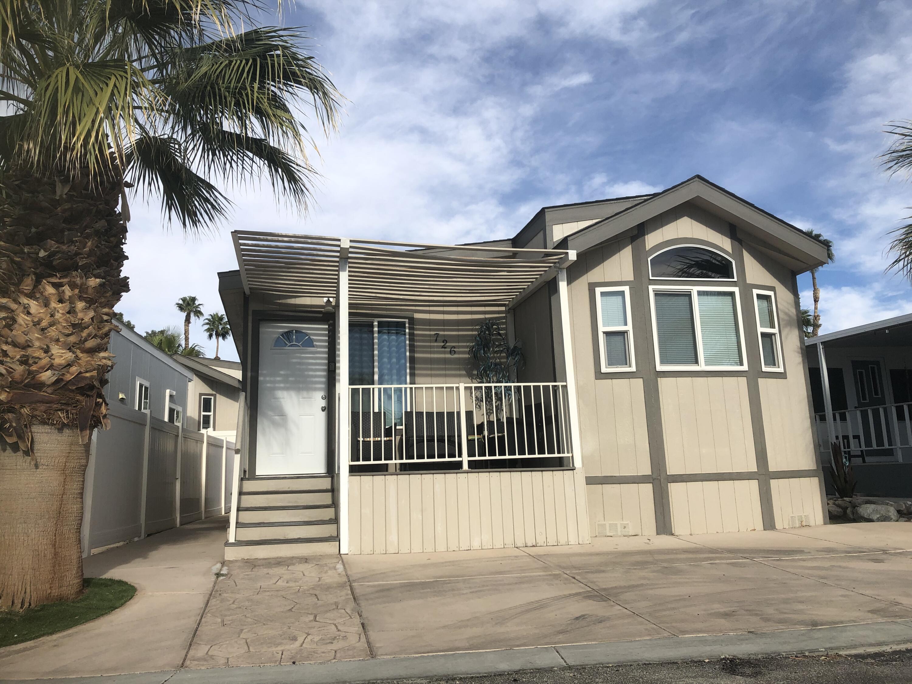 74711 Dillon Road Desert Hot Springs, CA 92241 - Photo 1 of 44 a front view of a house with a garden