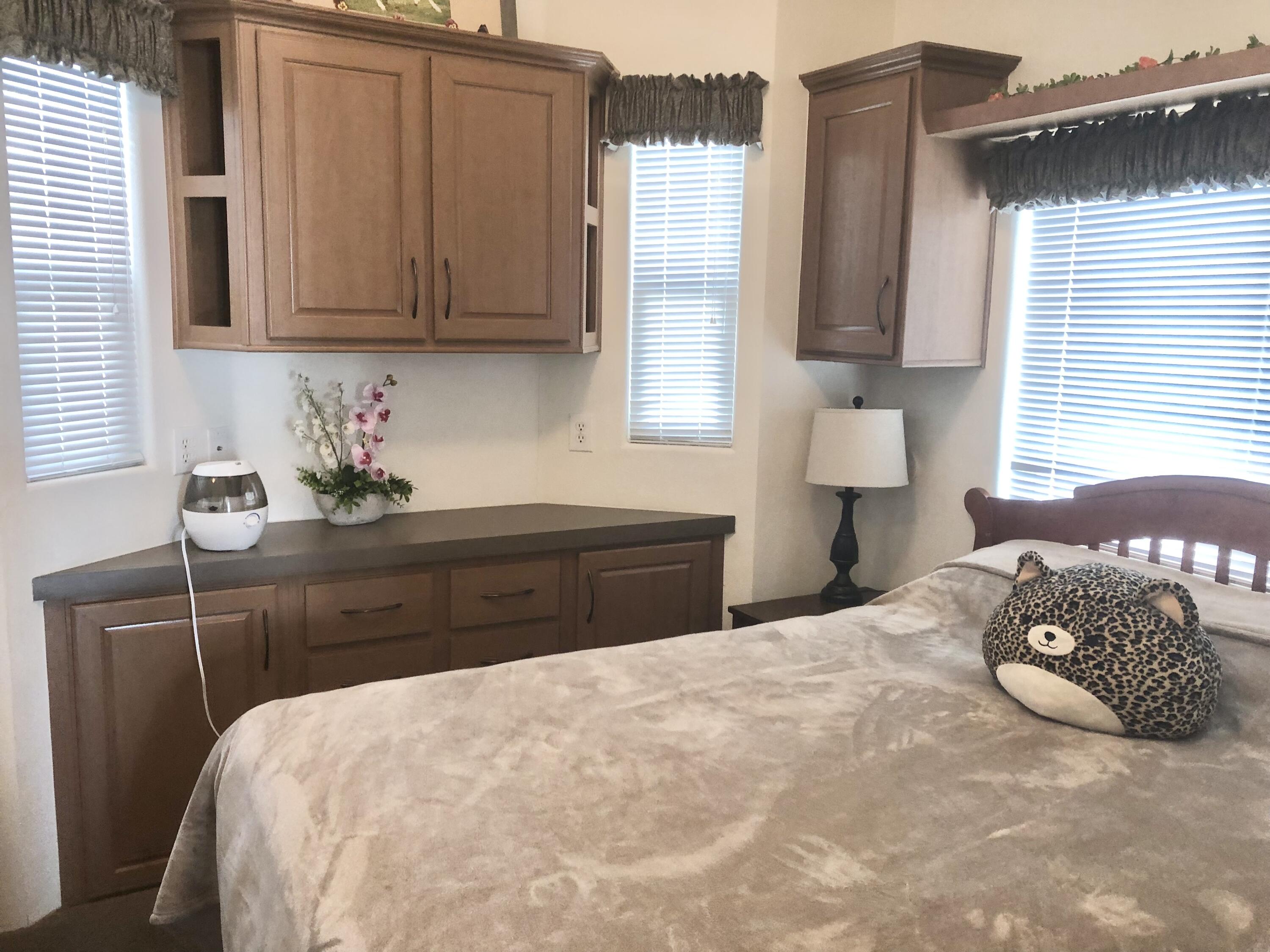 74711 Dillon Road Desert Hot Springs, CA 92241 - Photo 13 of 44 a bedroom with a bed and window