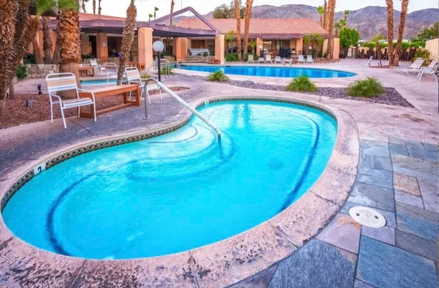 a view of a swimming pool with a lounge chairs