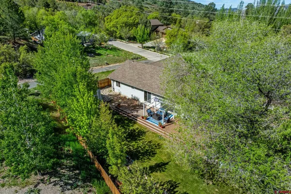 an aerial view of residential houses with outdoor space and street view