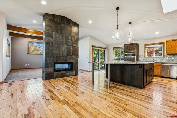 a kitchen with stainless steel appliances granite countertop wooden cabinets a oven and a sink