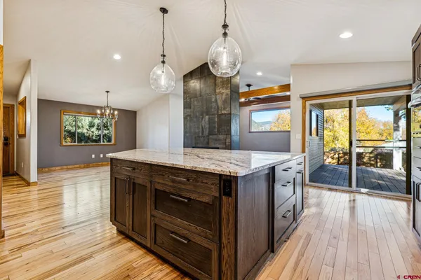 a kitchen with stainless steel appliances granite countertop wooden cabinets a sink and a window