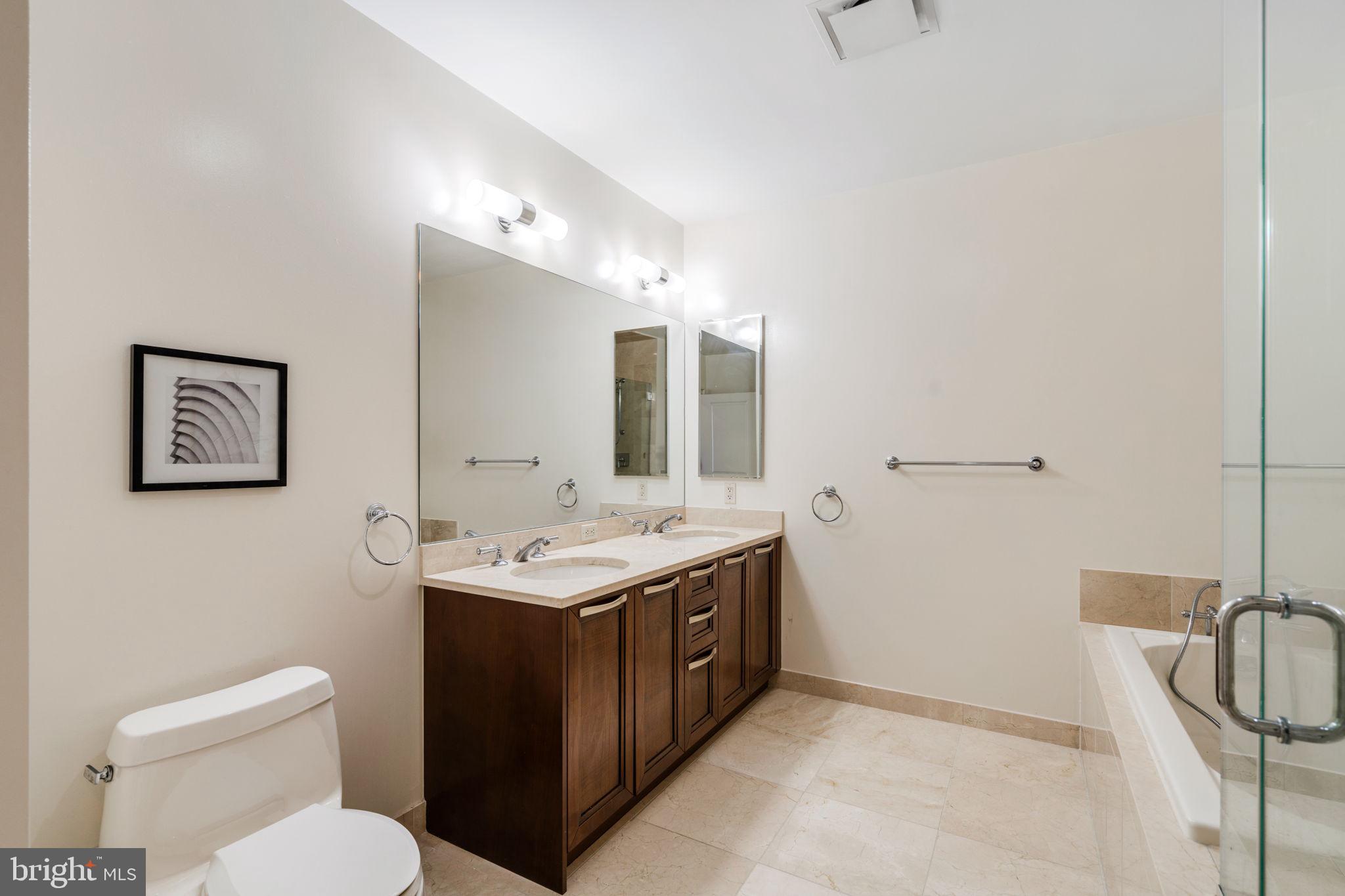 50 South 16th Street, Unit 4304 Philadelphia, PA 19103 - Photo 11 of 43 a bathroom with a toilet a sink and mirror