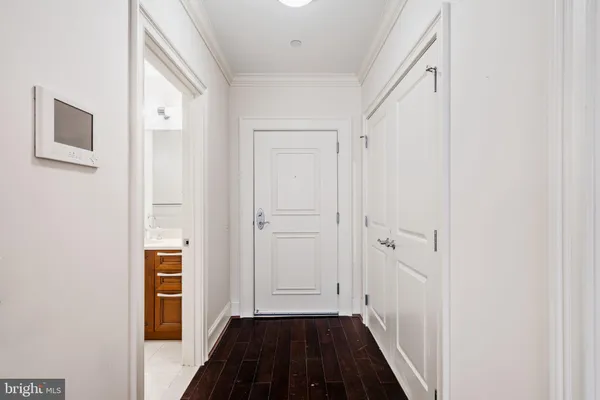 a view of a hallway with wooden floor and closet