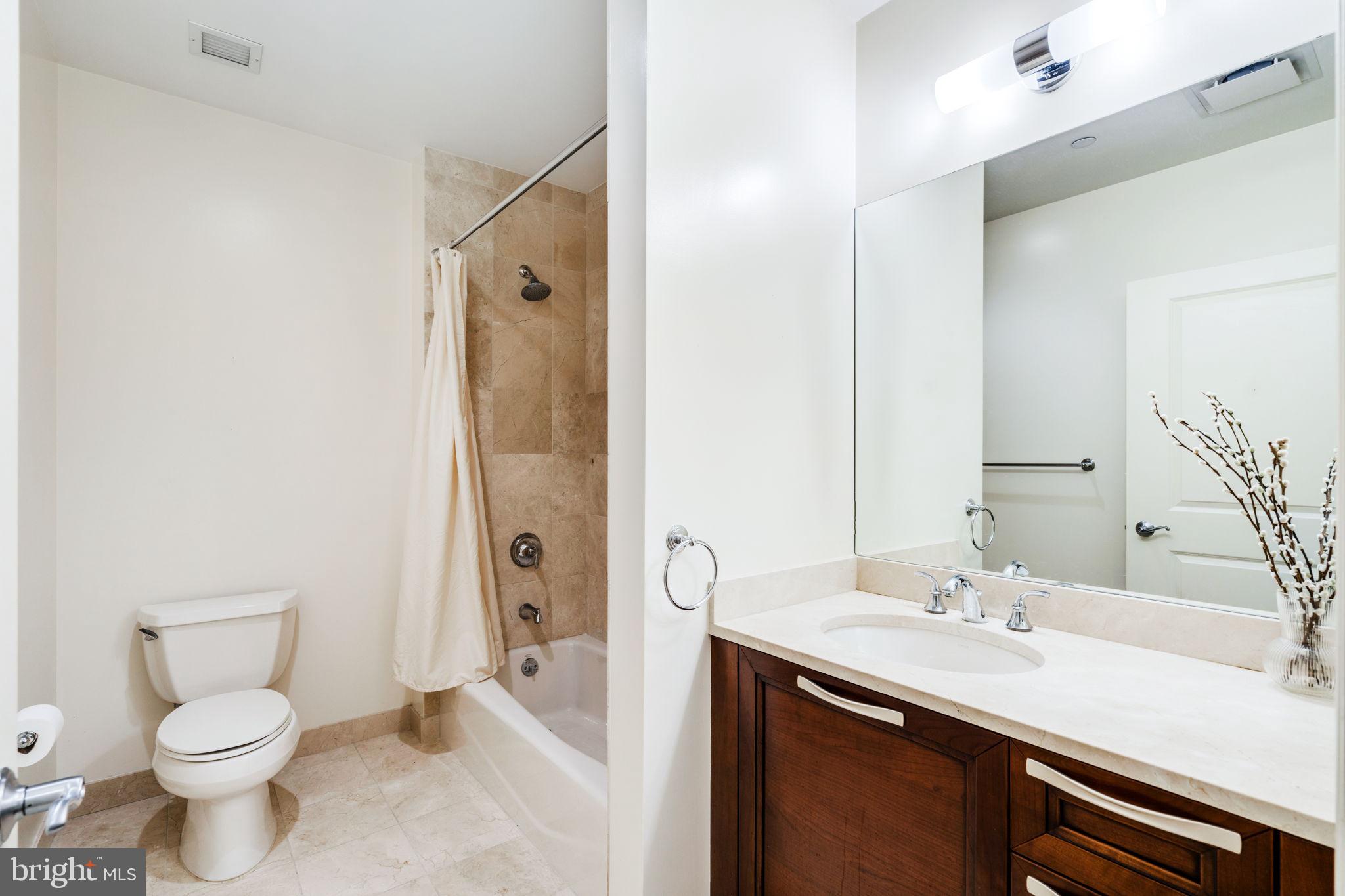 50 South 16th Street, Unit 4304 Philadelphia, PA 19103 - Photo 17 of 43 a bathroom with a sink toilet vanity and shower